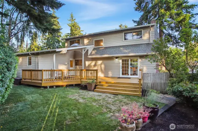 Quiet and serene fenced back yard with sprawling freshly painted deck.