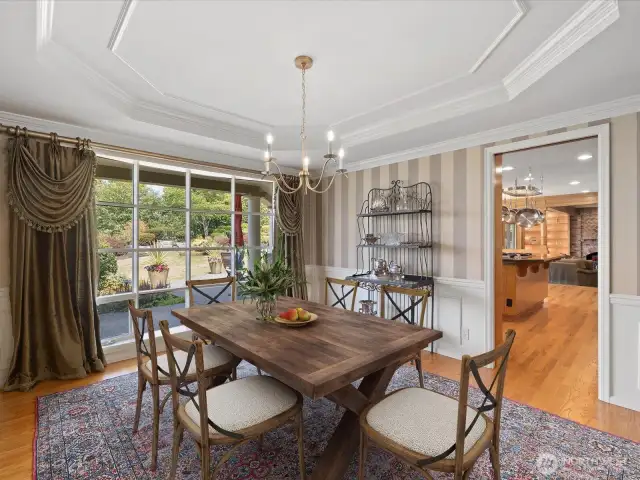 Virtually Staged Formal Dining Room with Coffered Ceilings and Views....