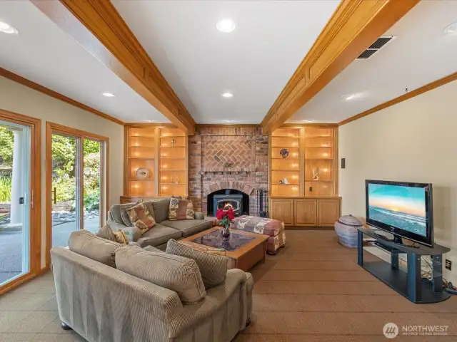 Family Room with Oak Wrapped Beams, Wood Burning Stove, Built-in Shelves, Cabinets and Custom Lighting