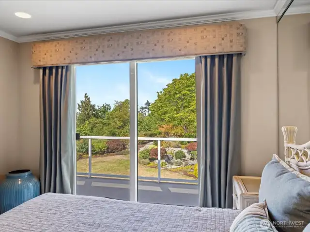 Bedroom #2 Access to the Deck and Views of Puget Sound, the Lush Mature Landscaping, Cascading Water Feature, and PNW Sunsets.