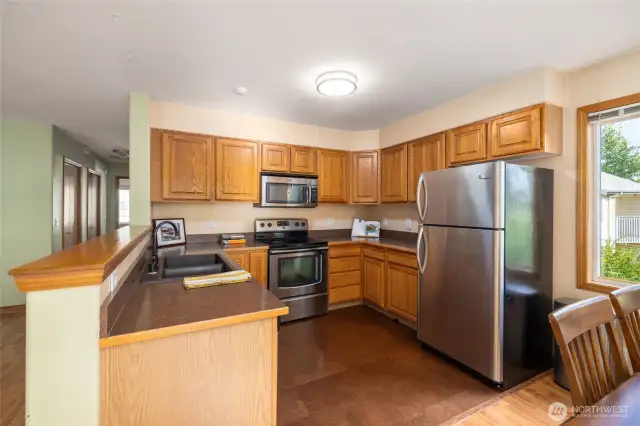 Kitchen has upgraded appliances and sink.