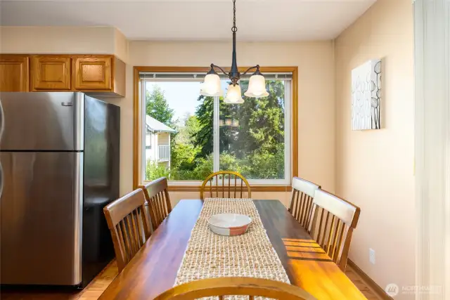 Dining room has large window and slider to the balcony.