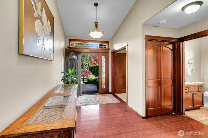 From the kitchen, take in a view of the entryway and the front door opening to beautifully maintained landscaping.