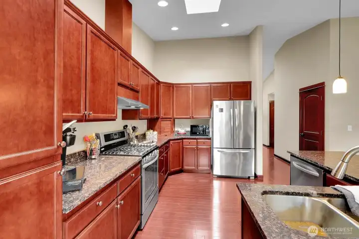 Granite countertops and stainless steel appliances.