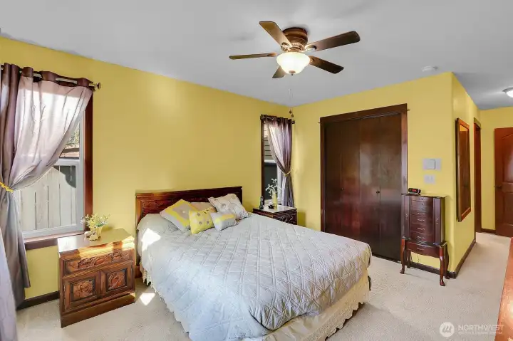 The primary bedroom showcases designer inspired colors and a spacious walk-in closet for ample storage.