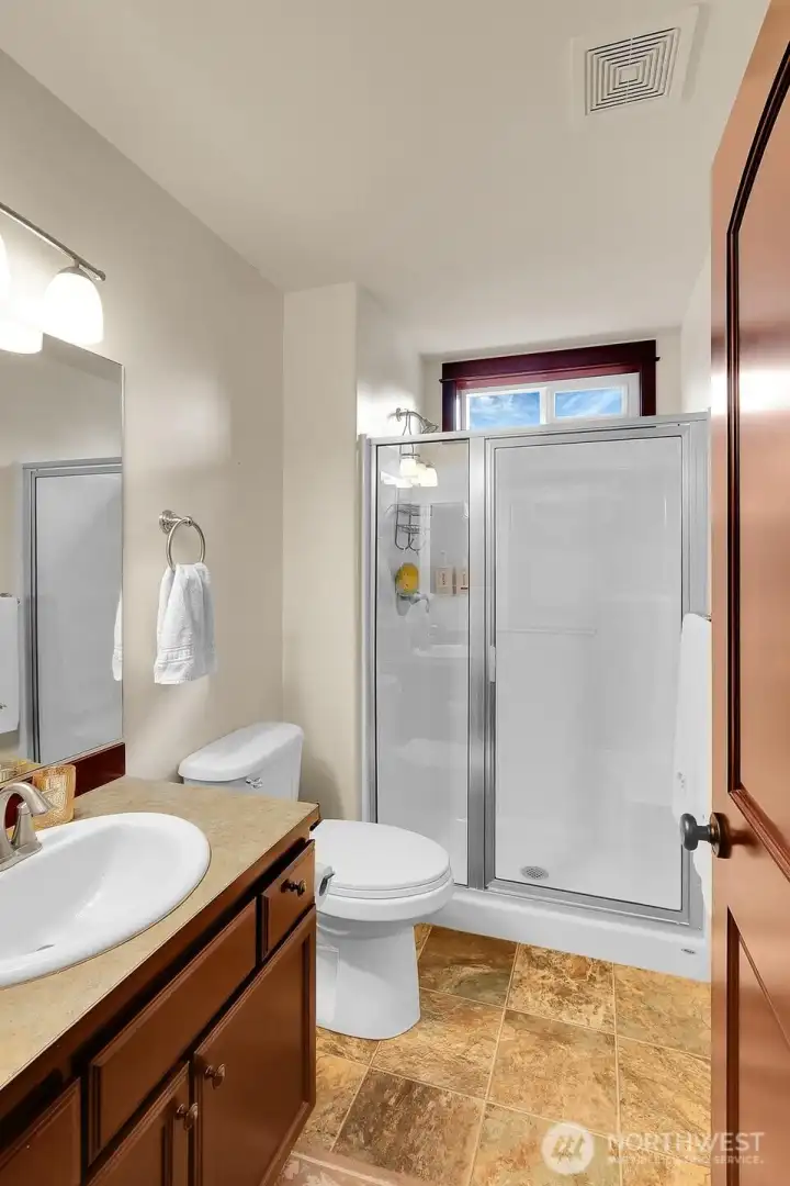Ideal for guests, the 3/4 bath is nestled between the two secondary bedrooms.
