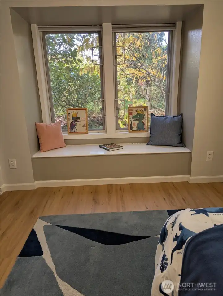 Charming window seat with storage in entry level bedroom