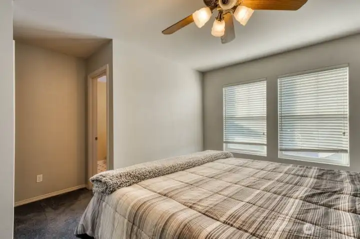 Primary looking at full bath on the right with walk-in closet directly across.