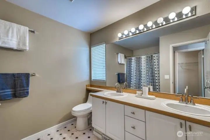 Primary ensuite with double sinks and combination bath tub and shower.