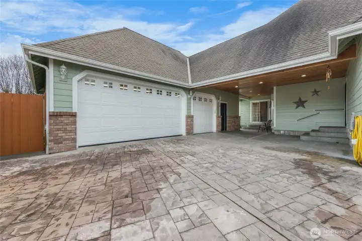 Covered breezeway with stamped concrete connecting garage/home