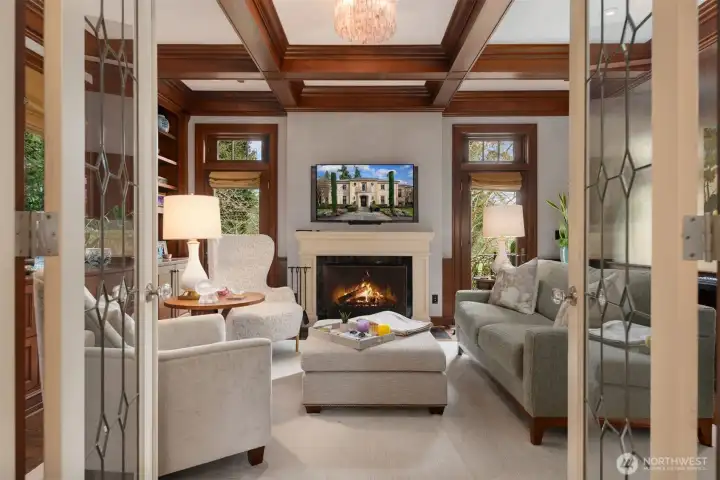 Beautiful library or sitting room with fireplace and custom millwork.