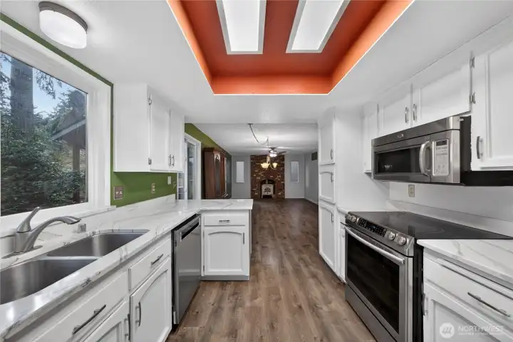 Open and bright kitchen with French doors to the spacious fenced yard.