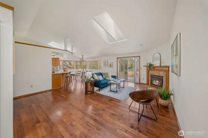 This angle emphasizes the serene view outside the dining area windows and to the paver patio deck outside the sliding door.  Again, so much natural light with vaulted ceilings and double skylights.