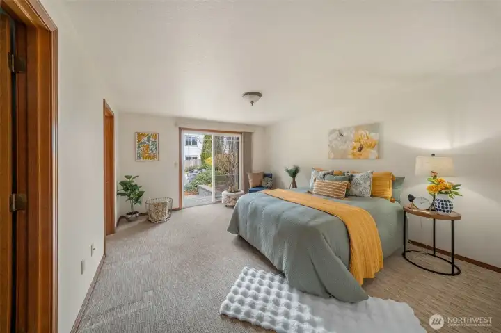 The primary bedroom is a relaxful oasis with a slider to the paver patio and a view of the water feature and its' soothing sound. So peaceful!