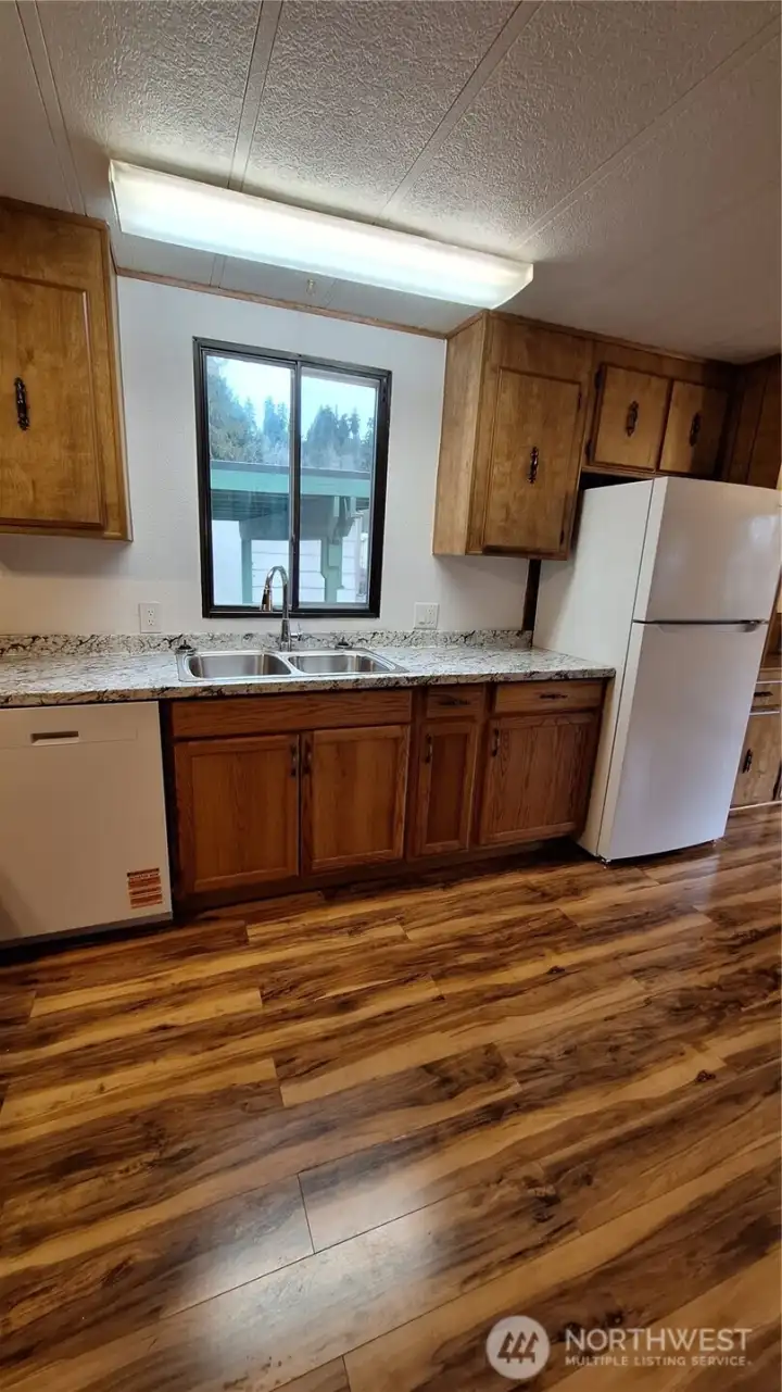 Move in ready!! enjoy all the new appliances in this open well designed kitchen.  new: Range refrigerator dishwasher PLUS new stainless sink with New Kohler faucets & countertop.New over head lighting over range and Sink.