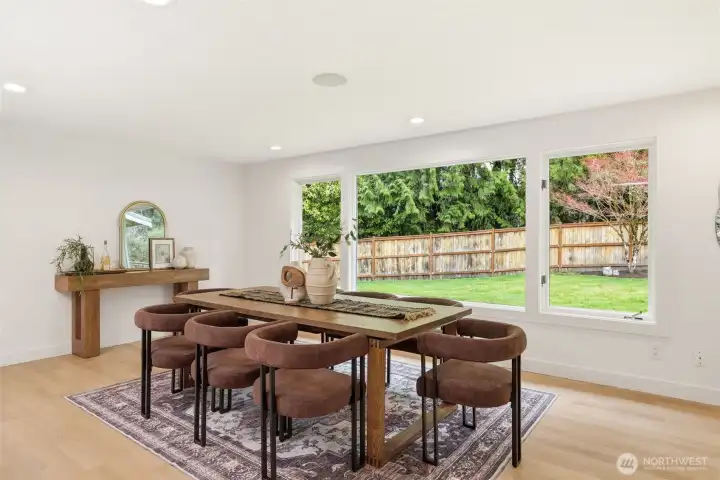 Dining area overlooking private backyard and greenery