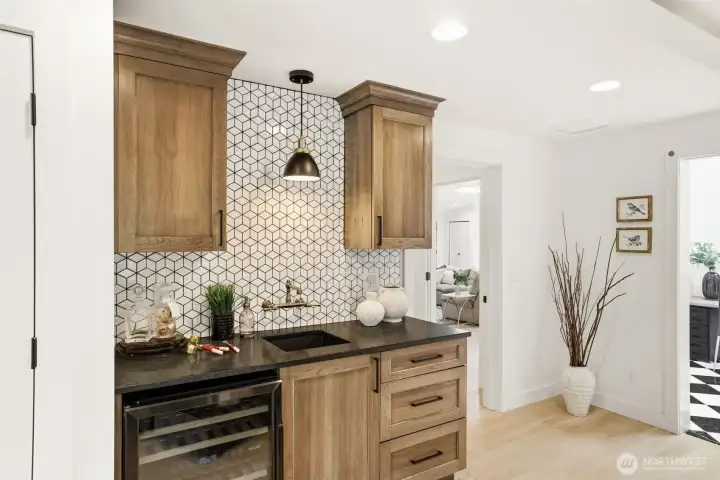 Stylish wet bar with custom cabinetry and storage