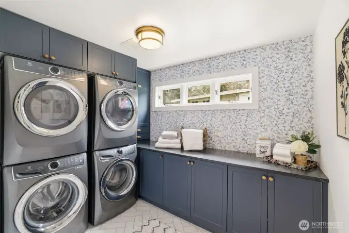 Well-designed laundry room with dual washer and dryer setup