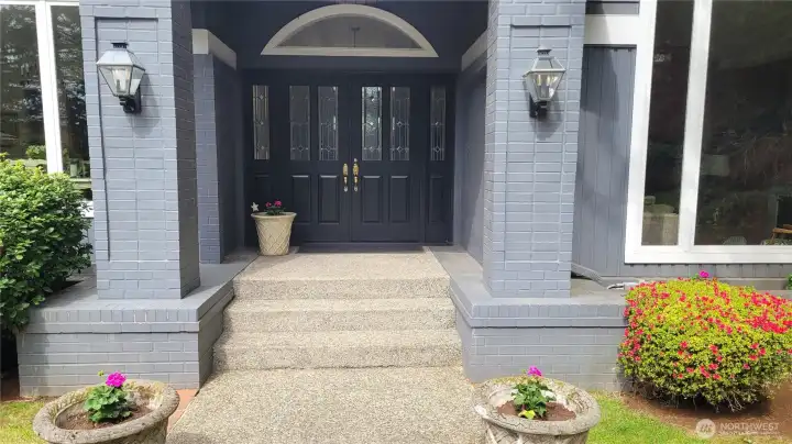 Large, covered porch leads to double  privacy glass windowed doors with sidelights and arched window above combine for an impressive entry for guests and a natursal light filled foyer!