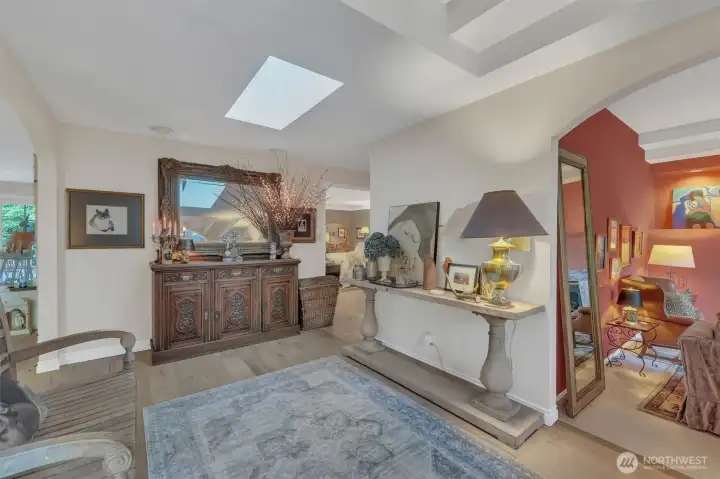 To the right of the foyer is the formal living room/den with gas fireplace, enormous picture window and tall celings and no neighbors in sight!