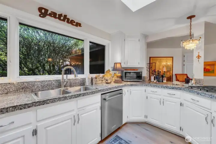 Triple window over the sink and granite counters.