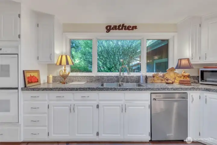 White cabinets, stainless steel dishwasher and refrigerator.