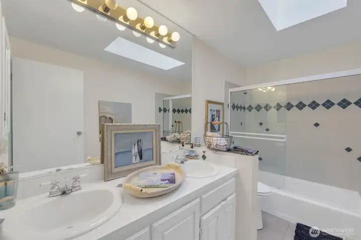 @nd full bathroom for the 3 additional bedrooms has a skylight, tile floors and tile shower.