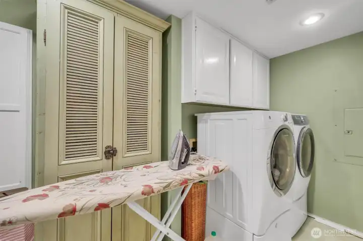 Large laundry room with toilet and sink and room to keep your ironing board out!