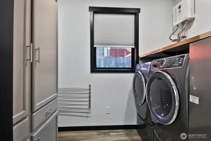 Utility Room with built in cabinets, tankless water heater. Utility Room with built in cabinets, tankless water heater.