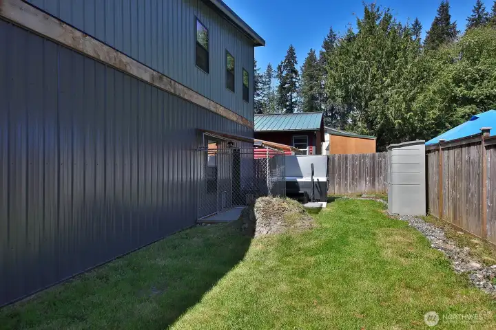 Backyard with dog run and hot tub. Backyard with dog run and hot tub.
