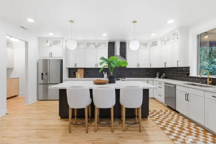 Quartz kitchen island and so many cabinets.