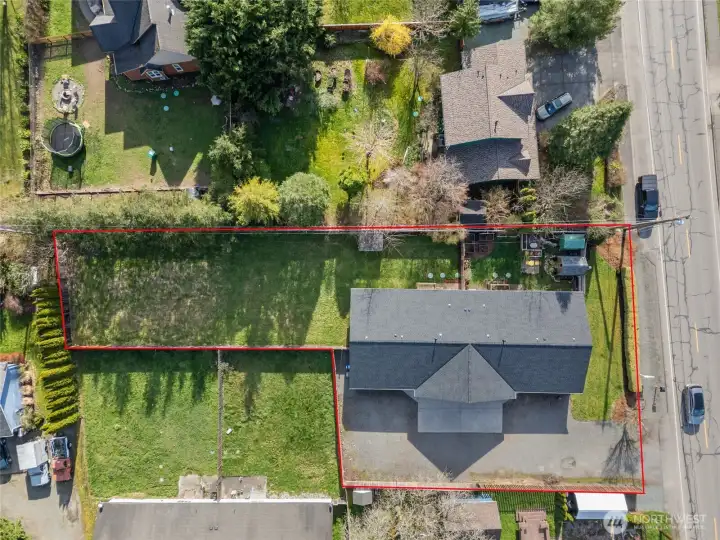Aerial view showing the entire property. Unit A with the spacious yard is on the left. Fence separates the two yards.   a