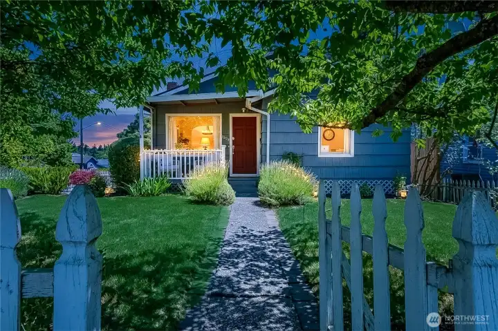 Storybook entry through the white picket fence.