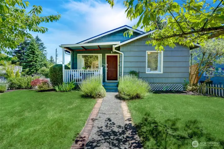 Beautiful front yard with 2 cherry blossom trees framing the entrance.