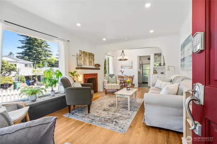 Gorgeous hardwoods welcome you in through the red front door.