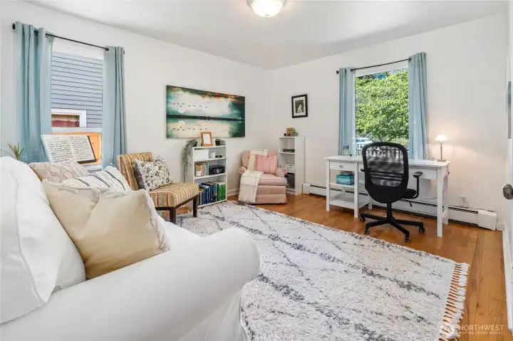 The front bedroom has been used as an office and music practice space.