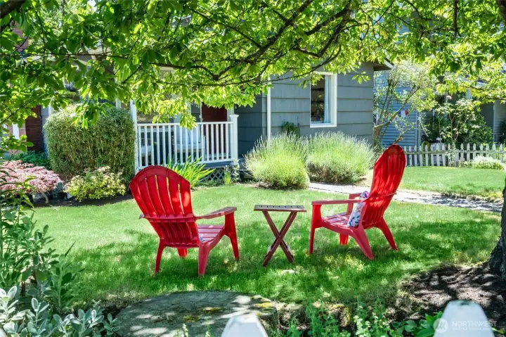 Enjoy sitting under the cherry blossoms in this fabulous yard.