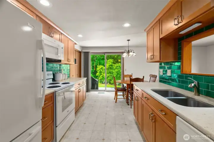 Remodeled kitchen with quartz counters and tile backsplash Remodeled kitchen with quartz counters and tile backsplash