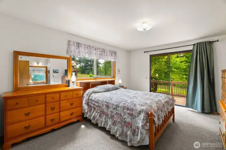 The sliding door off the primary bedroom leads to a private deck The sliding door off the primary bedroom leads to a private deck
