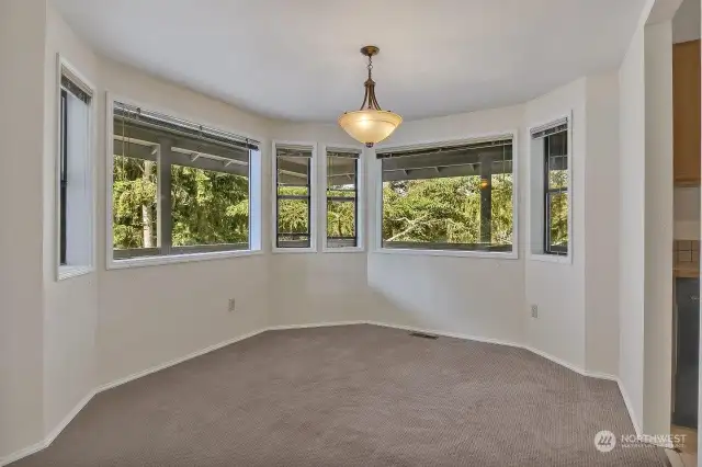 The formal dining room is adorned with a row of windows.