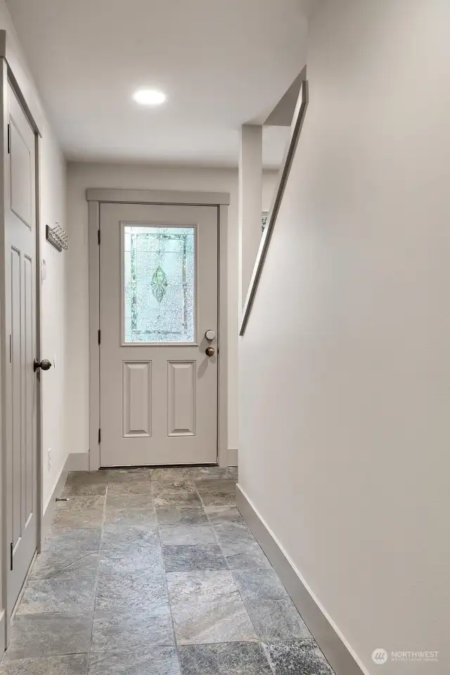 Let's head down to the ground level. That is the slate-tiled front entry; the door on the left takes you into the attached garage.