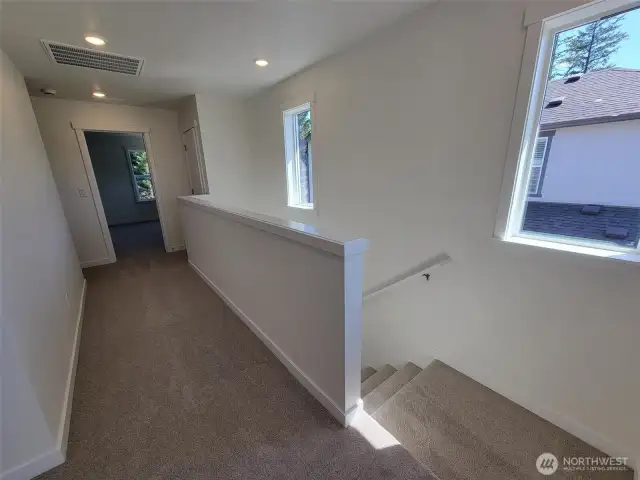 stairs up to loft and hall to primary bedroom