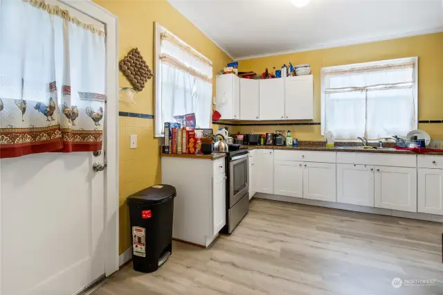 Unit 704A Kitchen with backyard exit. Not shown in this photo is the right end of kitchen in unit 704A whick has a washer & dryer there