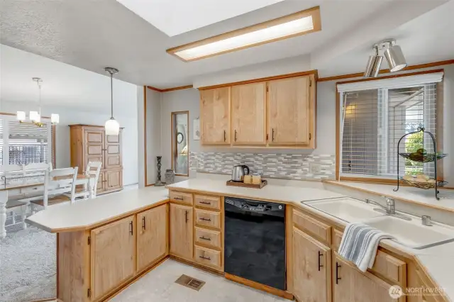 Kitchen has abundant cabinet and countertops, including a pantry next to fridge
