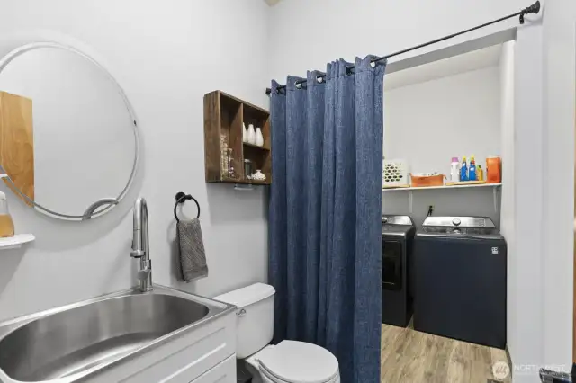 a charming 1/2 half bath with laundry- accessible from house and near interior garage door for muddy days