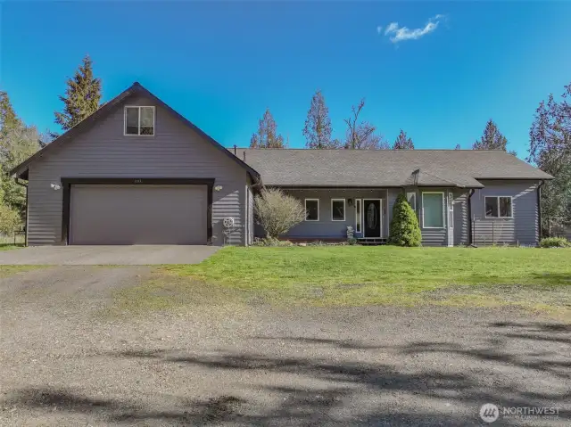 A well maintained gravel drive on a quiet road brings you to your Harstine Homestead
