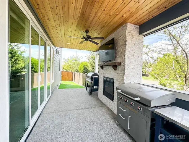 Covered back patio, gas fireplace, tv and double doors.