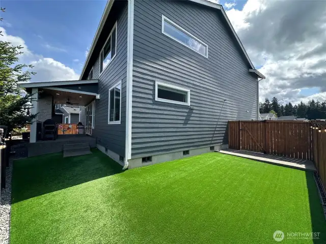 Backyard with turf lawn.