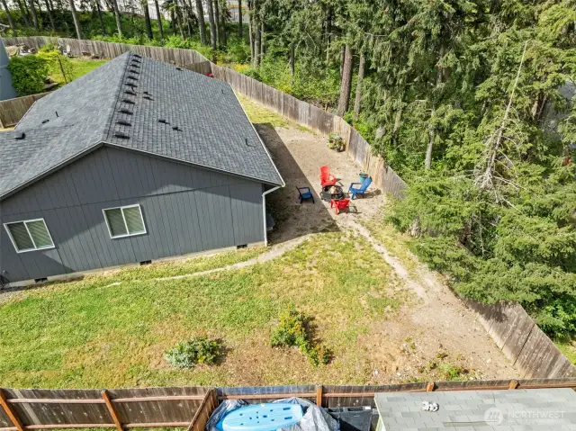 Your backyard is surround by tall evergreens giving you year round privacy. original grass, not photo enhanced.