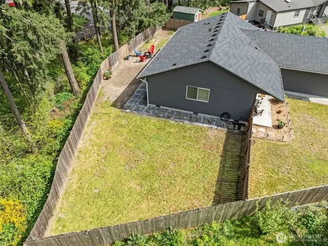Ample level backyard space, more than enough room for a garden, toys or entertaining. original grass, not photo enhanced.